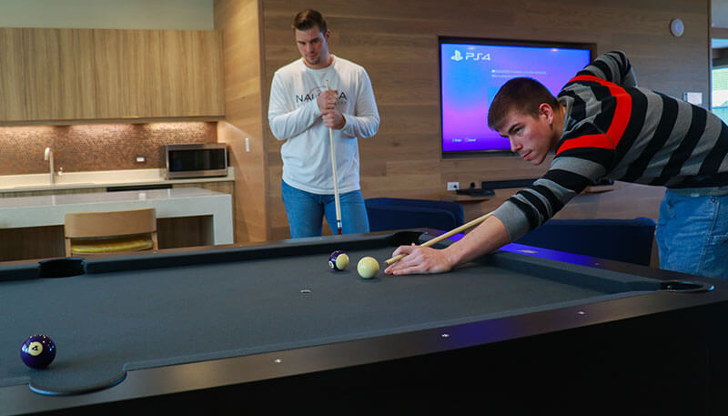 Students playing billiards at Lakeside Commons off campus student apartments